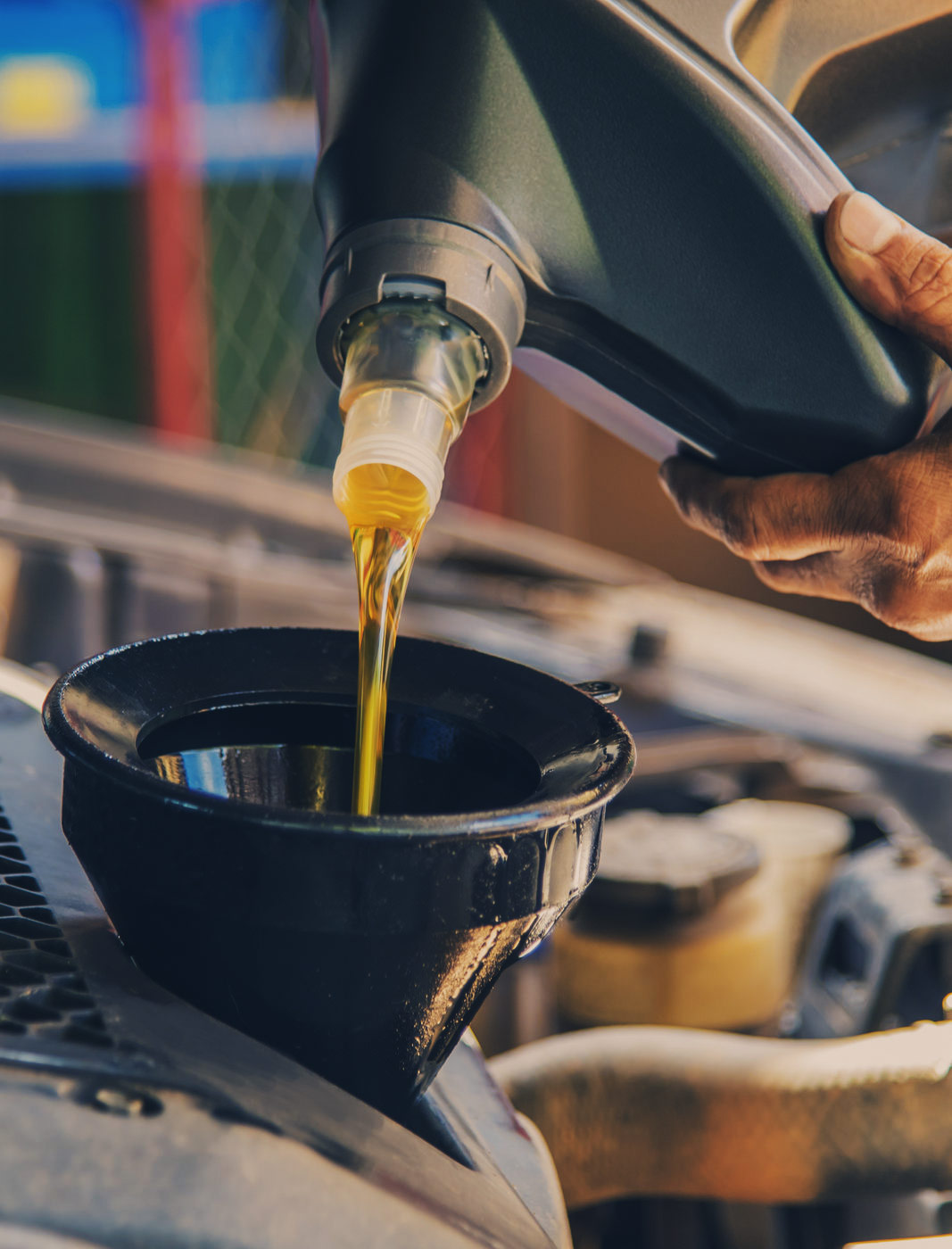 Mechanic pouring engine oil into a vehicle - Car Servicing Leighton Buzzard